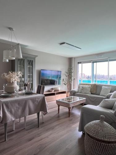 a living room with a couch and a table at El Balcón del Ebro by Alogest- Vistas, piscina y 2 parking in Zaragoza