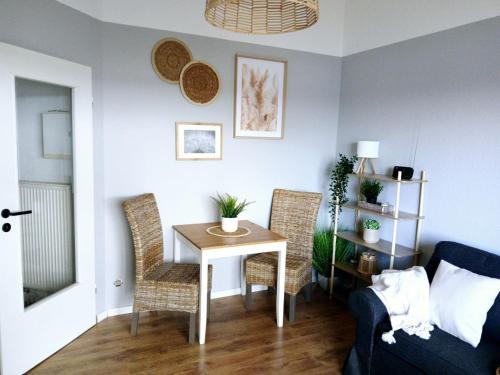 a living room with a table and chairs and a couch at Strandperle Timmel in Großefehn 