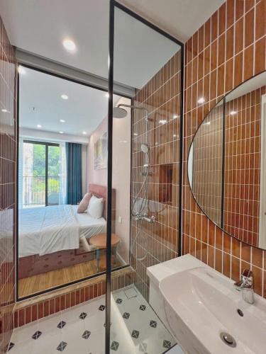 a bathroom with a shower and a bedroom with a bed at Skyline Hillside Apartment Phu Quoc in Phú Quốc