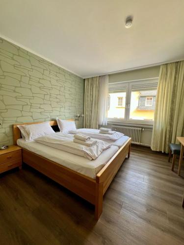 a bedroom with a large bed in a room at Hotel Haus Christa in Bad Bertrich