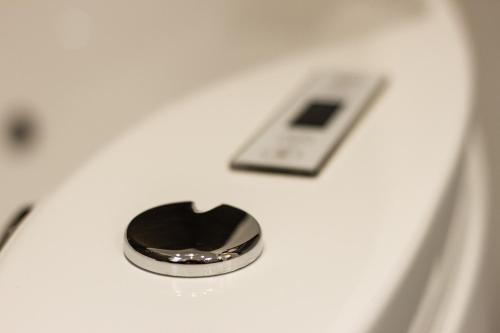 a heart shaped button on a toilet with a phone at Bianca Suite in Mantova