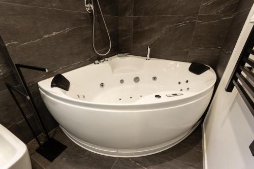 a white bath tub sitting in a bathroom at Bianca Suite in Mantova