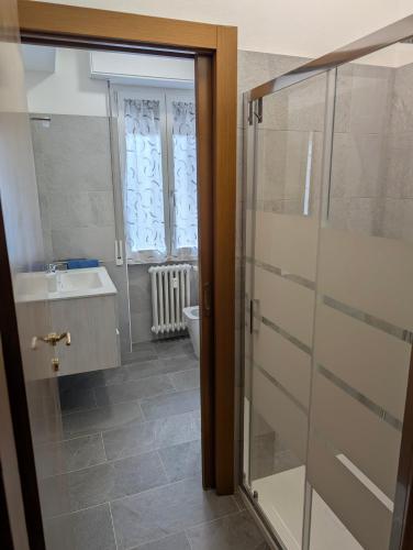 a bathroom with a shower and a sink and a toilet at Rholiday in Rho