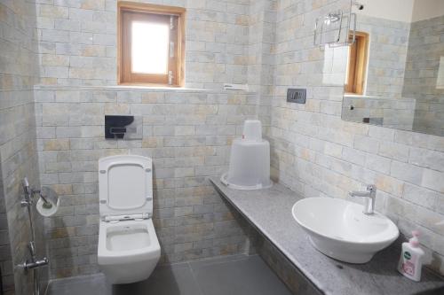 a bathroom with a toilet and a sink at D9 Restaurant and Hotel in Khetri