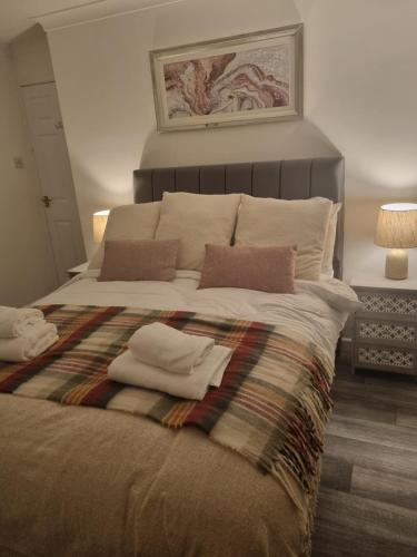 a bedroom with a bed with two towels on it at Central Apartment Newry City in Newry