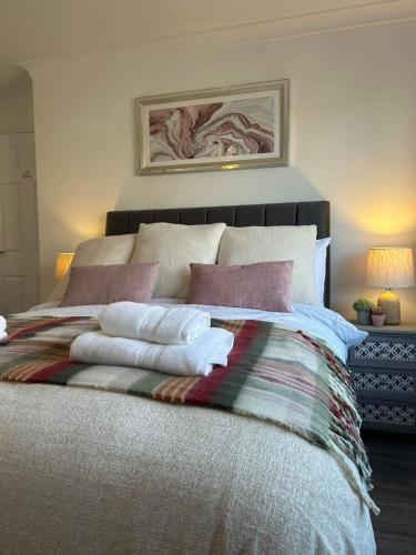 a bedroom with a bed with towels on it at Central Apartment Newry City in Newry