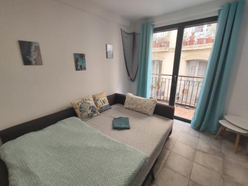 ein Wohnzimmer mit einem Bett und einem Fenster in der Unterkunft DUPLEX - 7min TO BEACH - HISTORIC CENTER in Alicante