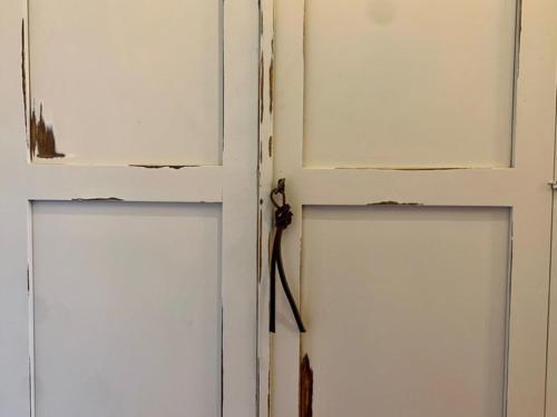 an open door with a broken window and a bat at Agriturismo Violati in San Gemini