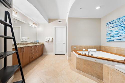 a large bathroom with a tub and a sink at Turquoise D1306 in Orange Beach