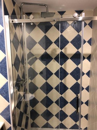 a shower with a black and white tiled wall at Casa FOR in Labuerda