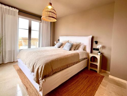 a bedroom with a large bed with a large window at Exclusive house in Finestrat in Cala de Finestrat