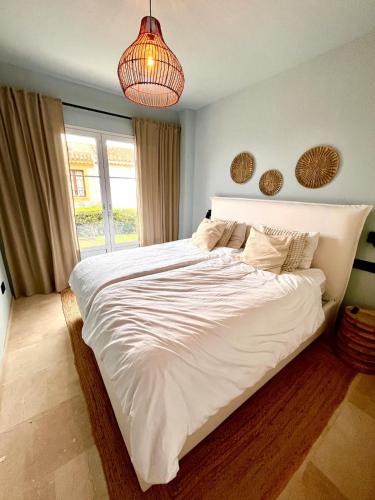 a large white bed in a room with a window at Exclusive house in Finestrat in Cala de Finestrat