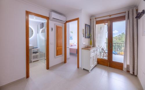 a large room with a bathroom with a balcony at LAS COLUMNAS in Port de Pollensa