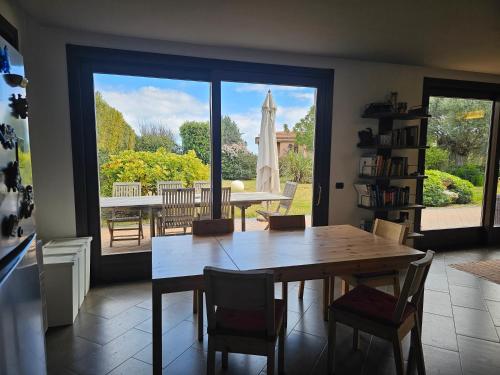 a dining room with a table and chairs and a window at Etna Home Garden in Viagrande
