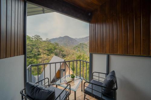 a balcony with chairs and a view of the mountains at Perfectstayz The Jungle Resort, Shivpuri in Shivpuri
