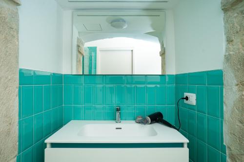 a bathroom with a sink and a mirror at B&B La Camelia Luxury Suite in Terlizzi