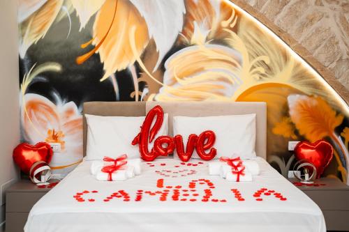 a bed with the word love written on it at B&B La Camelia Luxury Suite in Terlizzi