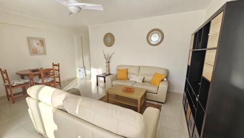 a living room with a white couch and a table at Apartamento Brisa Mar de Nerja in Nerja