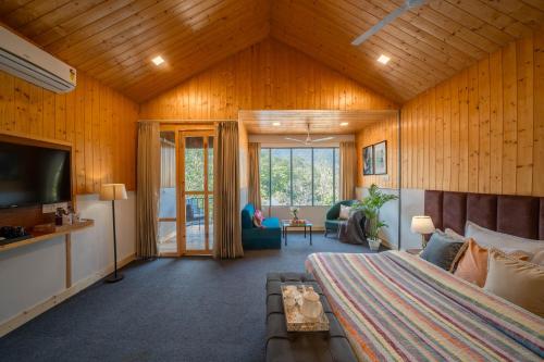 a bedroom with a bed and a tv in a room at Perfectstayz The Jungle Resort, Shivpuri in Shivpuri