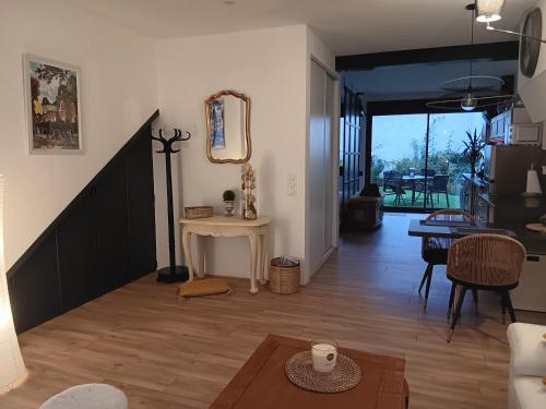- un salon avec une table et un miroir dans l'établissement Petit cocon au coeur de Vichy, à Vichy
