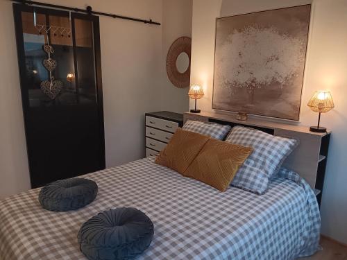 une chambre avec un lit avec deux oreillers dessus dans l'établissement Petit cocon au coeur de Vichy, à Vichy