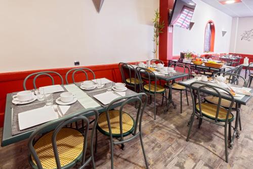 a dining room with tables and chairs in a restaurant at Hotel De Paris Jaligny in Jaligny