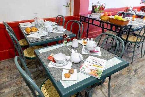 two tables in a restaurant with food on them at Hotel De Paris Jaligny in Jaligny