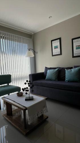 a living room with a couch and a table at Ballester's Dream in San Martín de los Andes