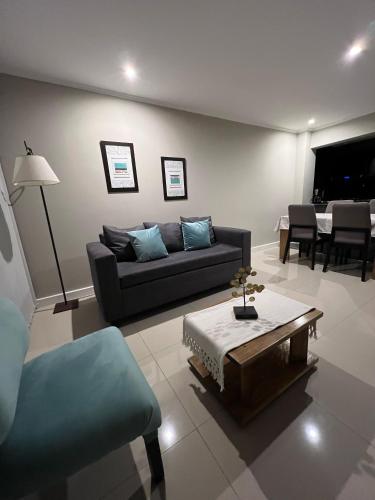 a living room with a couch and a table at Ballester's Dream in San Martín de los Andes