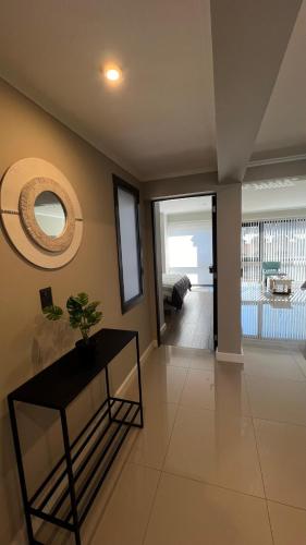 a living room with a table and a view of a pool at Ballester's Dream in San Martín de los Andes