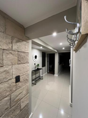 a hallway of a building with a stone wall at Ballester's Dream in San Martín de los Andes