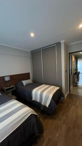 a bedroom with two beds in a room at Ballester's Dream in San Martín de los Andes