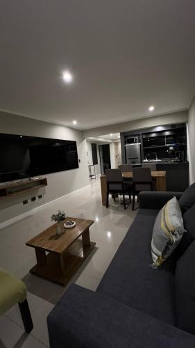 a living room with a couch and a table at Ballester's Dream in San Martín de los Andes
