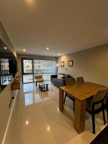 a living room with a table and a couch at Ballester's Dream in San Martín de los Andes