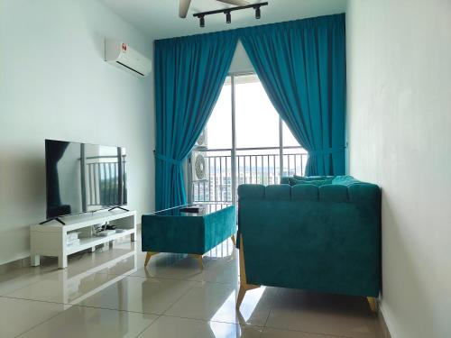 a living room with a blue couch and a window at Metropol Serviced Apartment - Bukit Mertajam, Penang in Bukit Mertajam
