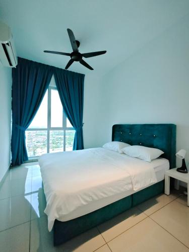 a bedroom with a bed with a ceiling fan at Metropol Serviced Apartment - Bukit Mertajam, Penang in Bukit Mertajam