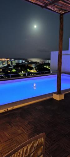 a view of a city at night from a roof at Baga Riviera in Playa del Carmen