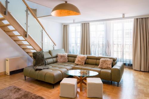 a living room with a couch and a table at Apartament w centrum - duplex penthouse in the centre with terrace and air conditioning in Krakow