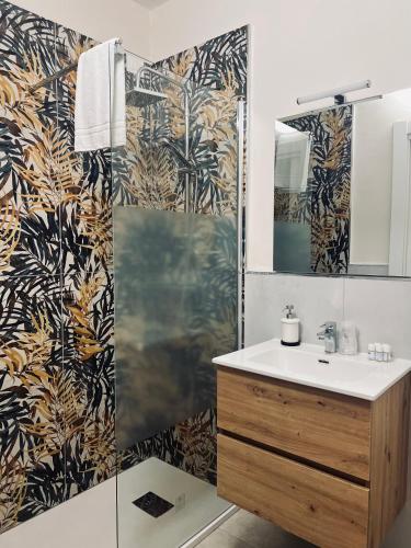 a bathroom with a shower with a sink and a mirror at Il Galileo Rooms in Pisa
