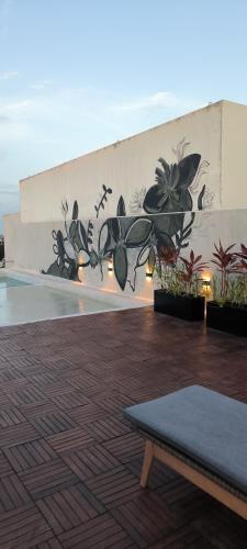a wall with a mural of flowers on it at Baga Riviera in Playa del Carmen
