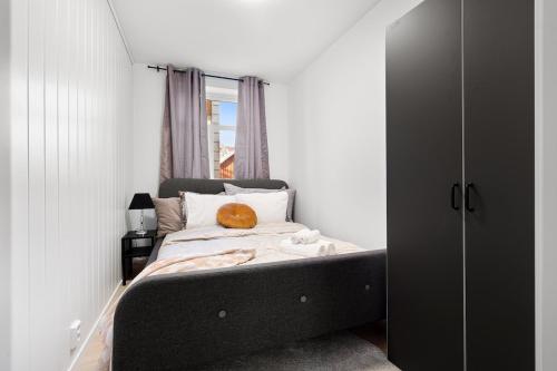 a bedroom with a bed with a pumpkin on it at Nord Apartments in Trondheim