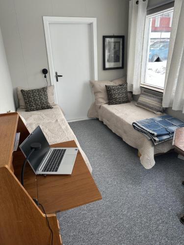a room with a desk and a laptop on a table at Comfortable house in Gryllefjord in Senja