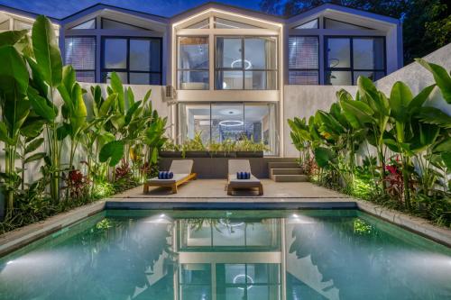 a house with a swimming pool in front of it at Loyo Villas in Tegalalang