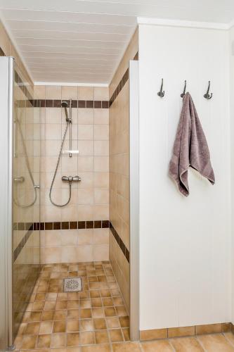 a bathroom with a shower with a glass door at Janebu - Premium RORBU Nusfjord in Ramberg