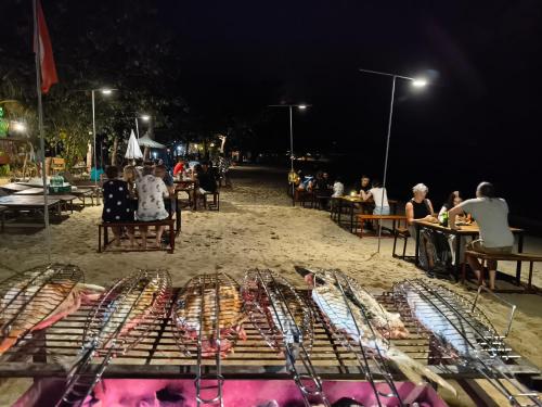 a beach at night with a bunch of fish in a cage at Yuyu Golden Beach in Ko Chang