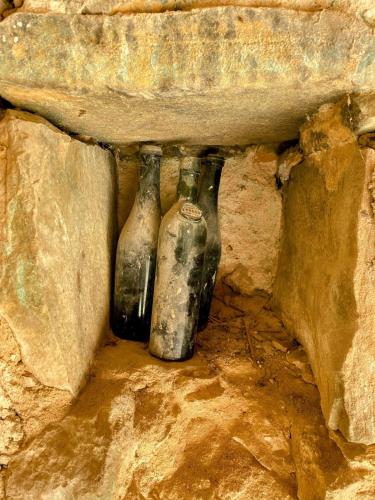 two old glass bottles sitting in a cave at Mas des Pelissiers Gîte in Sabran