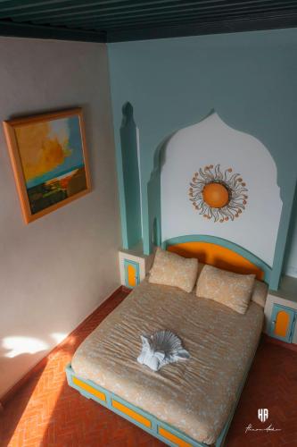 a bedroom with a bed with a cat laying on it at PALACIO AL ANDALUS in Chefchaouene