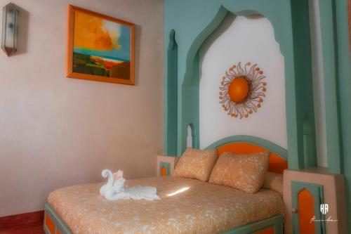 a bedroom with a bed with a toy rabbit on it at PALACIO AL ANDALUS in Chefchaouene