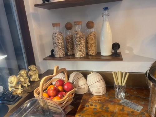 a kitchen counter with a basket of food and bottles of milk at Pension Ottenheide in Schloß Holte-Stukenbrock