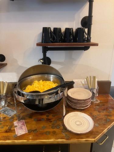 a bowl of food sitting on a counter with plates at Pension Ottenheide in Schloß Holte-Stukenbrock